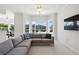 Spacious Gathering room featuring a sectional sofa and large windows with pool views at 29334 David Ct, Tavares, FL 32778
