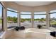 Bathroom with a corner tub and multiple windows with water views at 29334 David Ct, Tavares, FL 32778