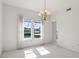 Bright dining room with large windows, chandelier, and pool view at 29334 David Ct, Tavares, FL 32778