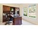 Home office with built-in wood desk and shelving at 29334 David Ct, Tavares, FL 32778