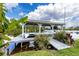 Covered boat dock with lift and serene water views at 29334 David Ct, Tavares, FL 32778