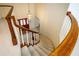 Elegant curved staircase with wood railings leading to the upper level at 29334 David Ct, Tavares, FL 32778