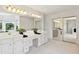 Bathroom with dual vanities, a large mirror, and a walk-in shower at 29334 David Ct, Tavares, FL 32778
