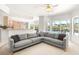 Bright Gathering room with a sectional sofa and open view to kitchen and pool at 29334 David Ct, Tavares, FL 32778
