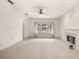 Spacious living room with a fireplace and large windows offering scenic views at 29334 David Ct, Tavares, FL 32778