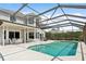 Inviting pool area with screened enclosure, spacious patio, and lush landscaping at 29334 David Ct, Tavares, FL 32778