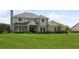 Two-story home with brick and siding exterior, and a spacious lawn at 29334 David Ct, Tavares, FL 32778