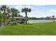 Private dock with covered boat storage and scenic views at 29334 David Ct, Tavares, FL 32778