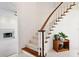 Elegant curved staircase with wood railings and carpet at 29334 David Ct, Tavares, FL 32778