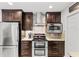 Updated kitchen, featuring stainless steel appliances and wood cabinets at 122 Baytree Blvd, Tavares, FL 32778