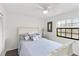 Charming bedroom with a sleigh bed and window with black trim at 122 Baytree Blvd, Tavares, FL 32778