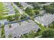 Aerial view showcasing townhouses, roads, and surrounding neighborhood at 122 Baytree Blvd, Tavares, FL 32778