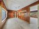 Living room with wood paneling and a view into the kitchen at 304 E Noble Ave, Bushnell, FL 33513