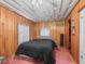 Cozy bedroom with a double bed and wood paneling at 304 E Noble Ave, Bushnell, FL 33513
