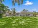 Large backyard with lush grass and mature trees at 304 E Noble Ave, Bushnell, FL 33513