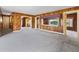 Living room with wood paneling, offering views of the backyard at 304 E Noble Ave, Bushnell, FL 33513