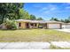 House exterior featuring a ranch-style home with a large yard and solar panels at 2270 Washington Rd, Mount Dora, FL 32757