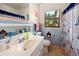 Bathroom with light blue tile and a nautical theme at 2270 Washington Rd, Mount Dora, FL 32757
