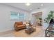 Living room with brown couch and view of kitchen at 1921 Dartmouth Ave, Winter Park, FL 32789