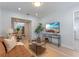 Living room with brown couch and view of kitchen at 1921 Dartmouth Ave, Winter Park, FL 32789