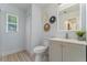 Modern bathroom with gray vanity, updated fixtures, and a toilet at 1921 Dartmouth Ave, Winter Park, FL 32789