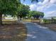 Long driveway leading to a ranch-style home at 2103 W Kelly Park Rd, Apopka, FL 32712