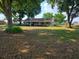 Ranch-style home with a front porch and large yard at 2103 W Kelly Park Rd, Apopka, FL 32712