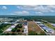 Aerial view of a large land plot near industrial buildings at 2103 W Kelly Park Rd, Apopka, FL 32712