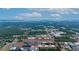Aerial view of a large land plot near industrial buildings at 2103 W Kelly Park Rd, Apopka, FL 32712