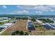 Aerial view of a large land plot near industrial buildings at 2103 W Kelly Park Rd, Apopka, FL 32712