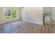 Living room with wood-look flooring, neutral walls, and ample natural light at 24801 Cranes Roost Cir, Leesburg, FL 34748