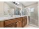Double vanity bathroom with a walk-in shower at 24801 Cranes Roost Cir, Leesburg, FL 34748