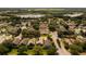 Aerial view of a community showcasing various houses and green spaces at 24801 Cranes Roost Cir, Leesburg, FL 34748