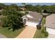 Single-story house with a driveway and a white garage at 24801 Cranes Roost Cir, Leesburg, FL 34748