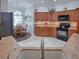Spacious kitchen featuring ample wood cabinets, granite countertops, and modern appliances at 1751 Ashwood Run, The Villages, FL 32162