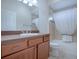 Clean bathroom with a shower/tub combo, wood vanity, and neutral tile at 1751 Ashwood Run, The Villages, FL 32162