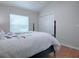 Bright bedroom with wood floors, a comfortable bed, and ample closet space at 1751 Ashwood Run, The Villages, FL 32162