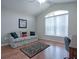 Home office featuring wood floors, a comfortable couch, and a large window at 1751 Ashwood Run, The Villages, FL 32162