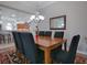 Bright dining room with a large wooden table and seating for eight at 1751 Ashwood Run, The Villages, FL 32162
