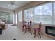 Bright sunroom with seating and fireplace at 1751 Ashwood Run, The Villages, FL 32162