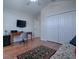 Versatile bedroom with wood floors and built-in workspace at 1751 Ashwood Run, The Villages, FL 32162