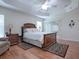 Main bedroom with a large bed, wood floors, and plenty of natural light at 1751 Ashwood Run, The Villages, FL 32162