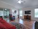 Living room with hardwood floors, vaulted ceiling, and plenty of natural light at 1751 Ashwood Run, The Villages, FL 32162