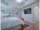 Main bedroom with wood floors, a large bed, and access to a lanai at 1751 Ashwood Run, The Villages, FL 32162