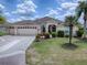Two-car garage and manicured lawn at 1751 Ashwood Run, The Villages, FL 32162