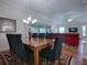 Open concept dining room with adjacent living room and access to the patio at 1751 Ashwood Run, The Villages, FL 32162