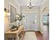 Bright and airy entryway with hardwood floors, console table, and decorative accents at 3682 Arlington Ridge Blvd, Leesburg, FL 34748