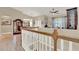 View of a home's interior, showcasing a staircase with wooden railing and tiled floor at 1000 Glenraven Ln, Clermont, FL 34711