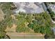 Aerial view of property with trees and cleared land at 26711 County Road 33, Groveland, FL 34736