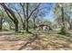 Small house with mature trees in the front yard at 26711 County Road 33, Groveland, FL 34736